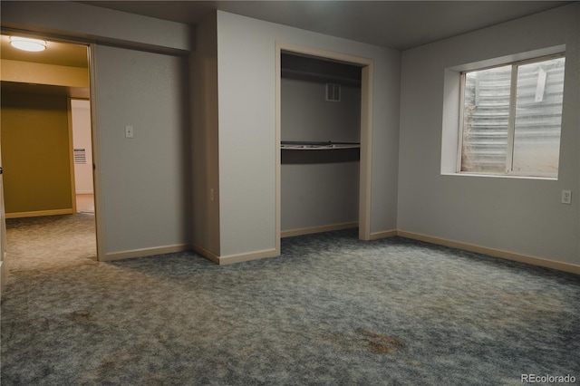 unfurnished bedroom featuring carpet and a closet