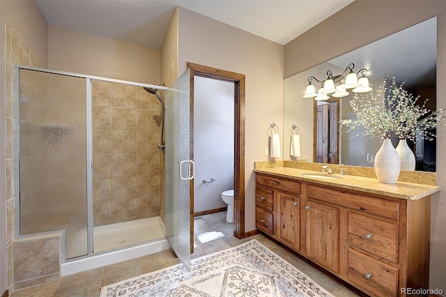 full bathroom with a shower stall, baseboards, toilet, tile patterned floors, and vanity