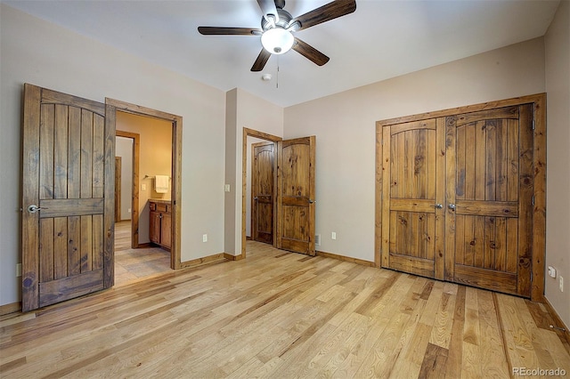 unfurnished bedroom featuring connected bathroom, baseboards, light wood-style floors, and a ceiling fan