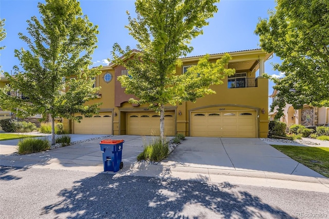 10127 Bluffmont Ln, Lone Tree, CO 80124 - view of front of house with stucco siding, driveway, a garage, and a balcony