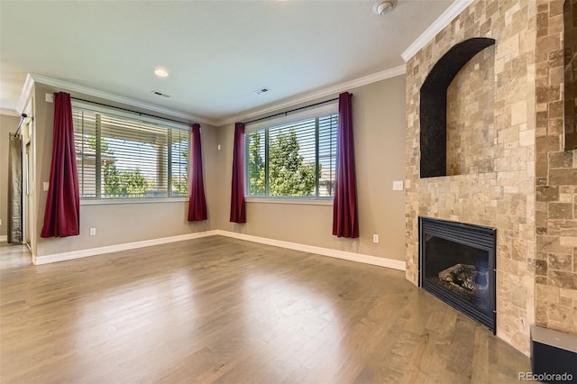 10127 Bluffmont Ln, Lone Tree, CO 80124 - unfurnished living room featuring ornamental molding, a fireplace, and wood finished floors