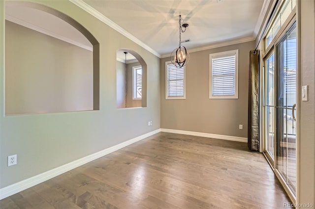 10127 Bluffmont Ln, Lone Tree, CO 80124 - unfurnished room featuring plenty of natural light, wood finished floors, ornamental molding, a chandelier, and arched walkways