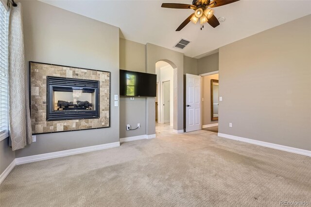 10127 Bluffmont Ln, Lone Tree, CO 80124 - unfurnished living room with ceiling fan, light colored carpet, and arched walkways
