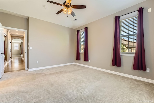 10127 Bluffmont Ln, Lone Tree, CO 80124 - unfurnished room featuring light colored carpet, a ceiling fan, arched walkways, and a smoke detector