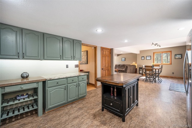 44 Conestoga Ct, Bailey, CO 80421 - kitchen with green cabinetry, light floors, baseboards, recessed lighting, and open shelves