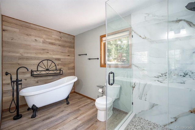 44 Conestoga Ct, Bailey, CO 80421 - bathroom with wooden walls, a freestanding bath, a marble finish shower, wood finished floors, and baseboards