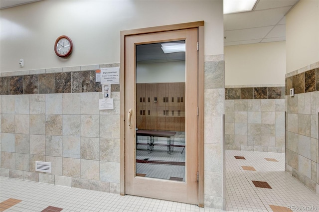 bathroom with tile walls and tile patterned floors