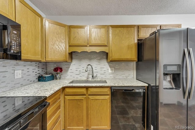 kitchen with tasteful backsplash, sink, a textured ceiling, and black appliances