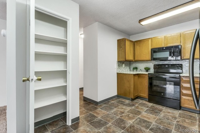 kitchen with backsplash, black appliances, and a textured ceiling