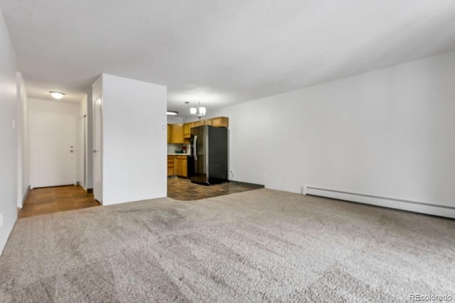 unfurnished living room with a baseboard radiator and light colored carpet