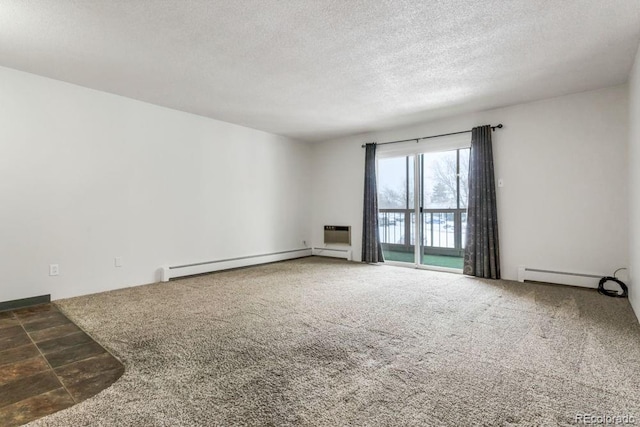 spare room with dark colored carpet, a baseboard heating unit, and a textured ceiling