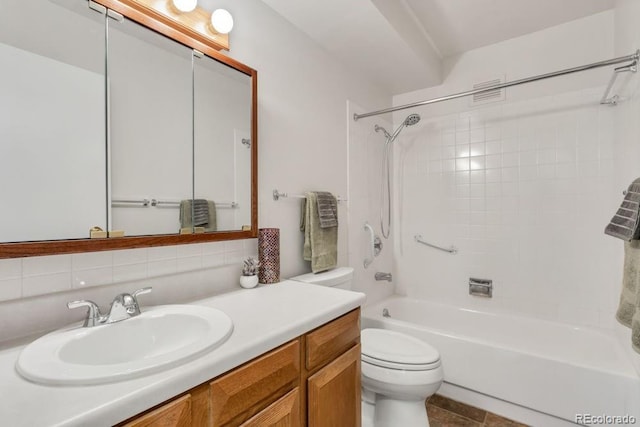 full bathroom with backsplash, tiled shower / bath combo, vanity, tile patterned flooring, and toilet