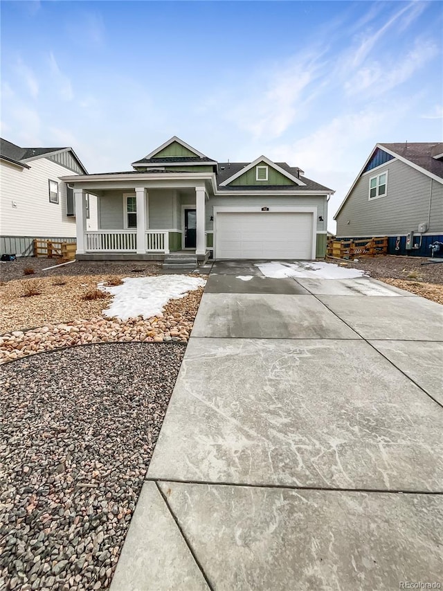 view of front of house featuring a porch, driveway, and an attached garage