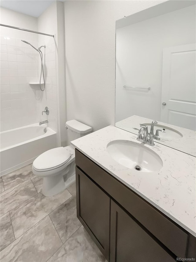 full bathroom with vanity, toilet, and tiled shower / bath