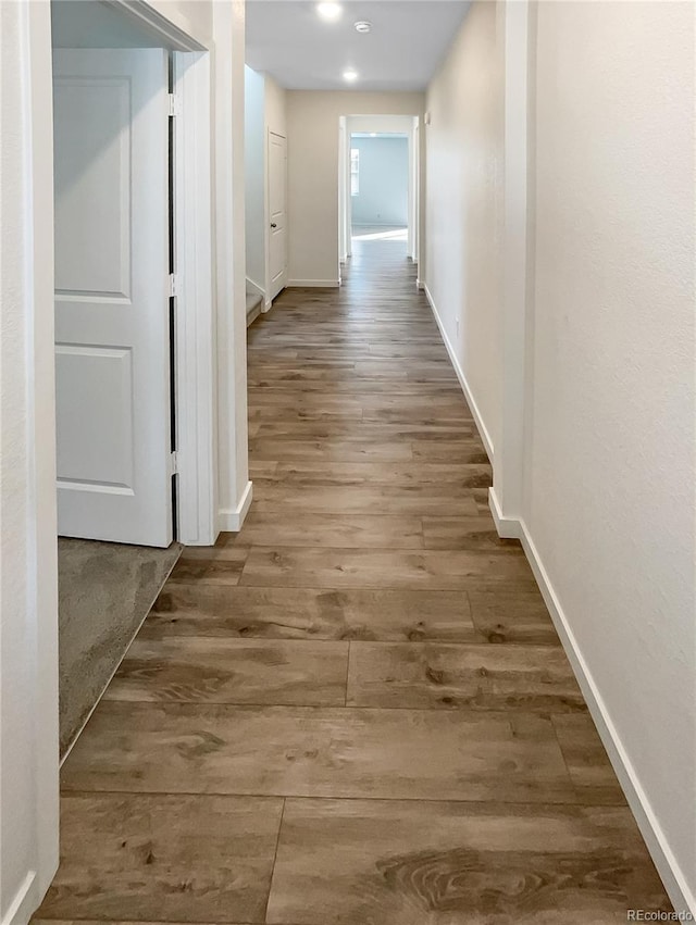 hallway with dark hardwood / wood-style floors