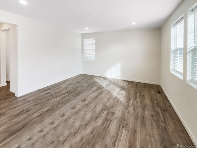 empty room with dark hardwood / wood-style flooring