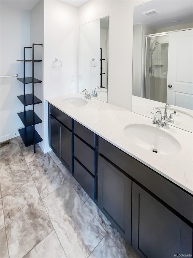 bathroom with vanity and a shower with door