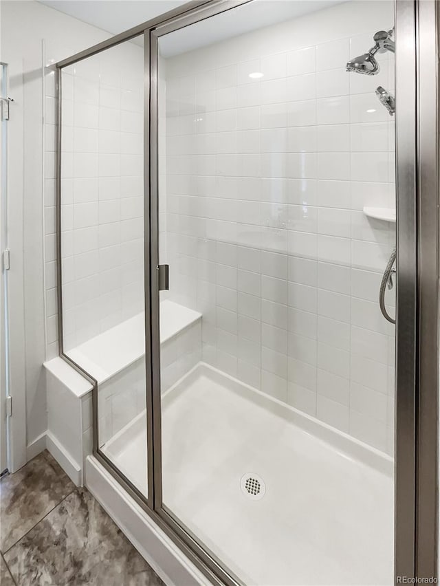 bathroom with a shower with shower door