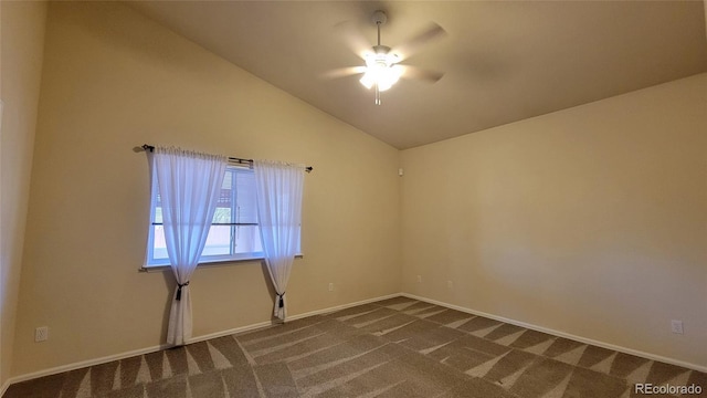 spare room with high vaulted ceiling, dark colored carpet, baseboards, and ceiling fan