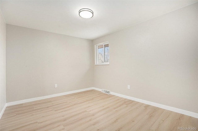 empty room with light hardwood / wood-style floors