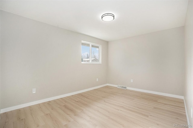 spare room featuring light hardwood / wood-style floors