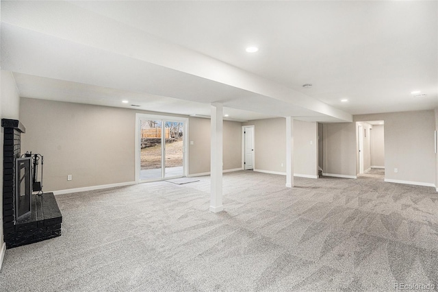 basement with light carpet and a fireplace