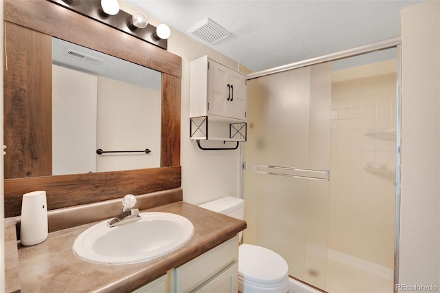 full bath featuring visible vents, a shower stall, toilet, and vanity