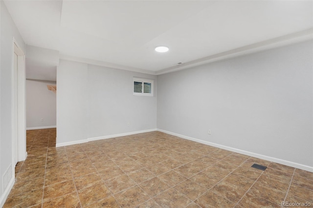 empty room featuring visible vents and baseboards