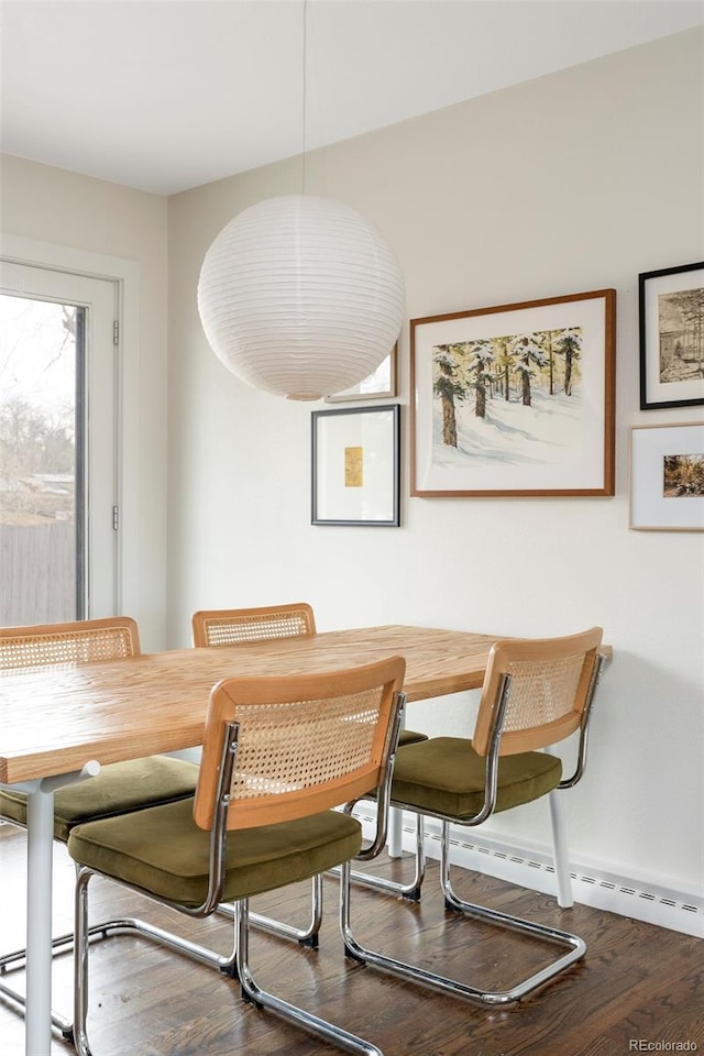 dining room with baseboards and wood finished floors