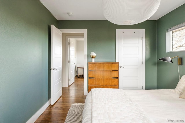 bedroom with wood finished floors and baseboards