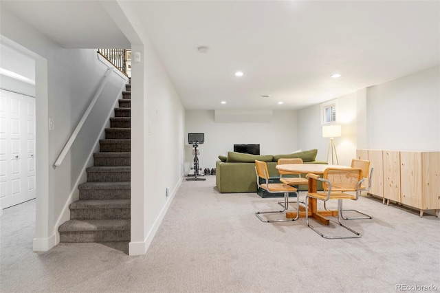 carpeted living room featuring stairway, baseboards, and recessed lighting