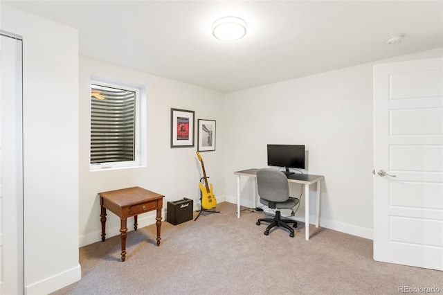 carpeted office space with baseboards