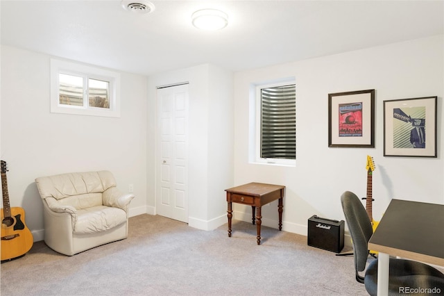 carpeted office space with visible vents and baseboards