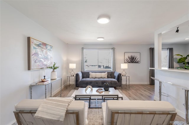 living room featuring light wood-style flooring and baseboards