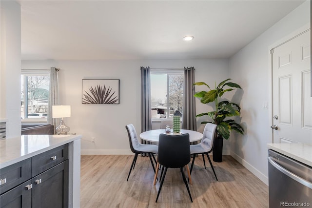 dining room with recessed lighting, baseboards, and light wood-style floors