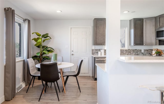 dining area with light wood finished floors, visible vents, and recessed lighting