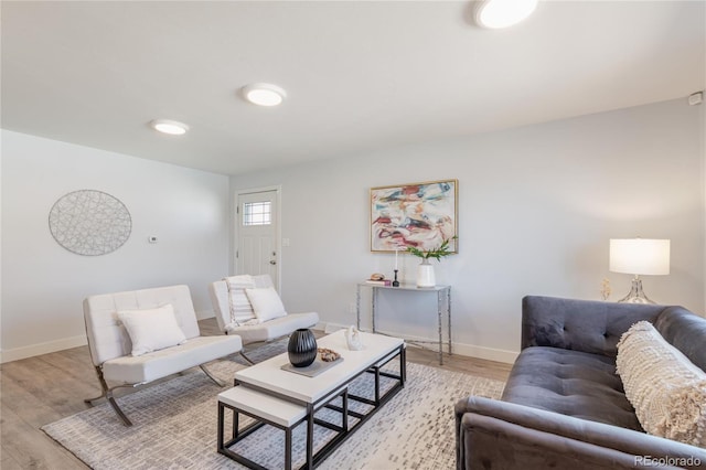 living room with light wood-type flooring and baseboards
