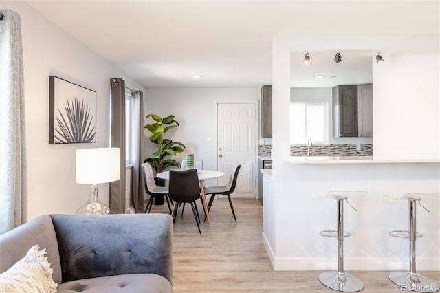 dining space with recessed lighting, light wood finished floors, and baseboards