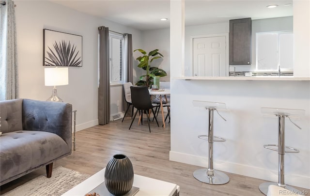 sitting room with recessed lighting, light wood-style floors, visible vents, and baseboards