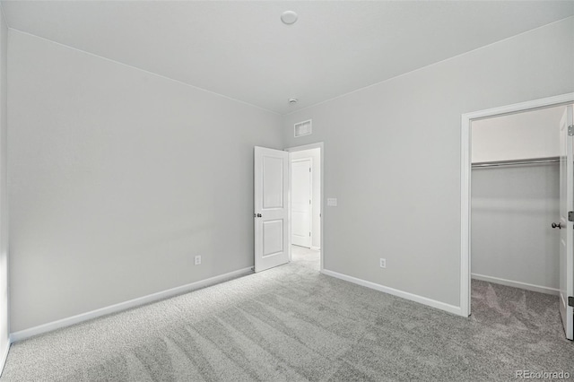 9374 Quartz St, Arvada, CO 80007 - unfurnished bedroom featuring carpet, baseboards, a walk in closet, and a closet