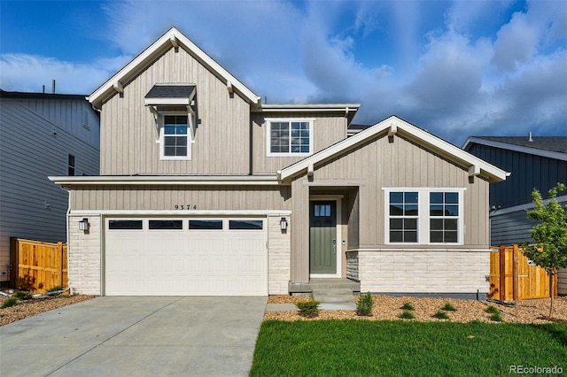 9374 Quartz St, Arvada, CO 80007 - view of front facade featuring stone siding, concrete driveway, and an attached garage