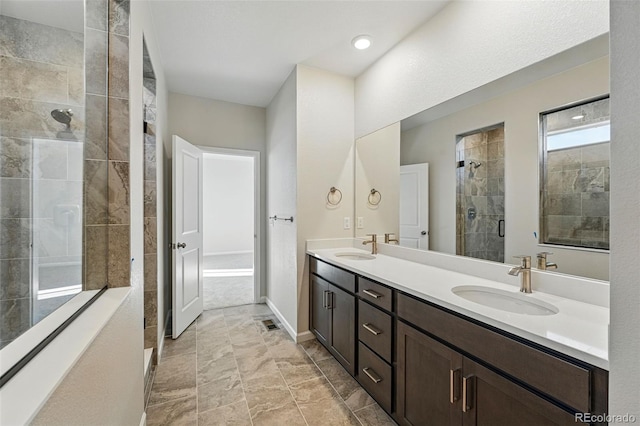 9374 Quartz St, Arvada, CO 80007 - full bathroom with double vanity, a tile shower, and baseboards