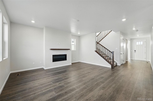 9374 Quartz St, Arvada, CO 80007 - unfurnished living room featuring stairway, recessed lighting, dark wood finished floors, plenty of natural light, and baseboards