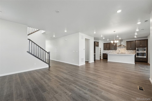 9374 Quartz St, Arvada, CO 80007 - unfurnished living room featuring a chandelier, recessed lighting, dark wood-style floors, stairway, and baseboards