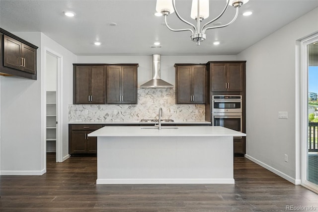9374 Quartz St, Arvada, CO 80007 - kitchen with wall chimney range hood, stainless steel double oven, dark wood-style flooring, dark brown cabinetry, and recessed lighting