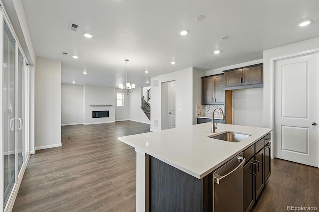 9374 Quartz St, Arvada, CO 80007 - kitchen with a sink, dishwasher, dark brown cabinets, dark wood-style floors, and baseboards