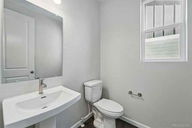 9374 Quartz St, Arvada, CO 80007 - half bath featuring baseboards, a sink, toilet, and wood finished floors