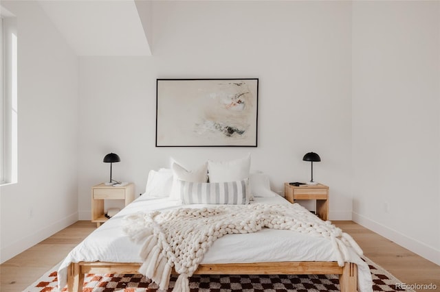 bedroom with baseboards and light wood-type flooring