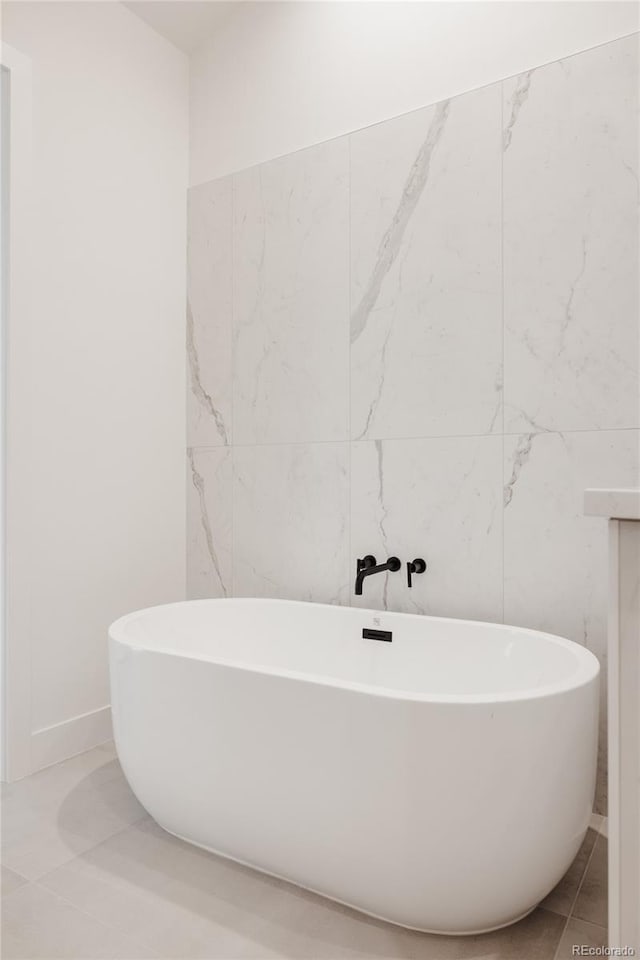 bathroom featuring tile patterned floors and a soaking tub