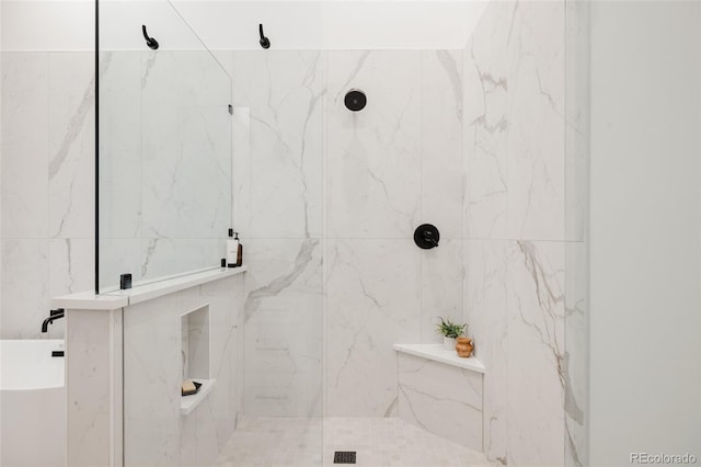 bathroom featuring a marble finish shower